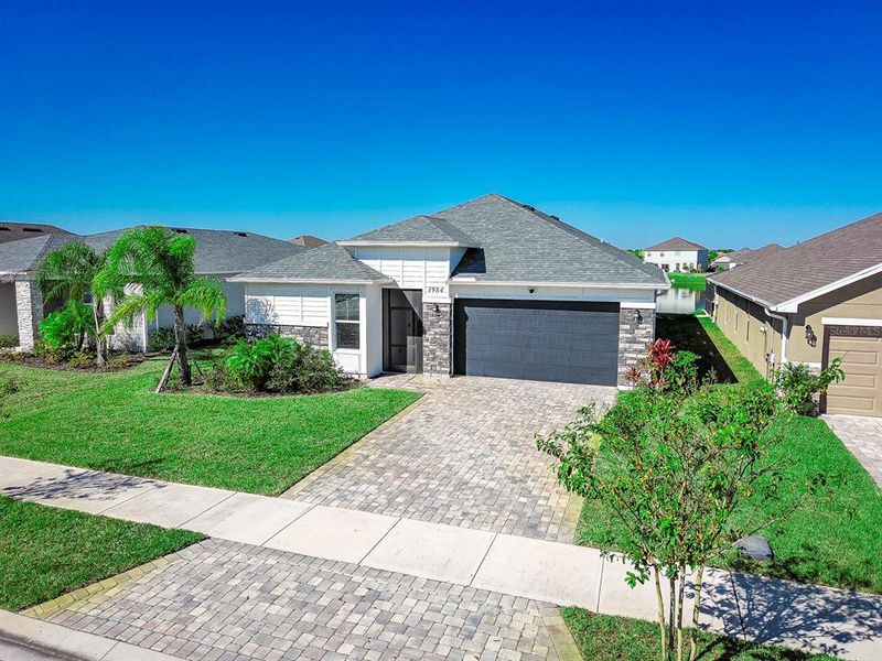 Front exterior of a new home in , Palm Bay, FL, highlighting curb appeal (Image 24).
