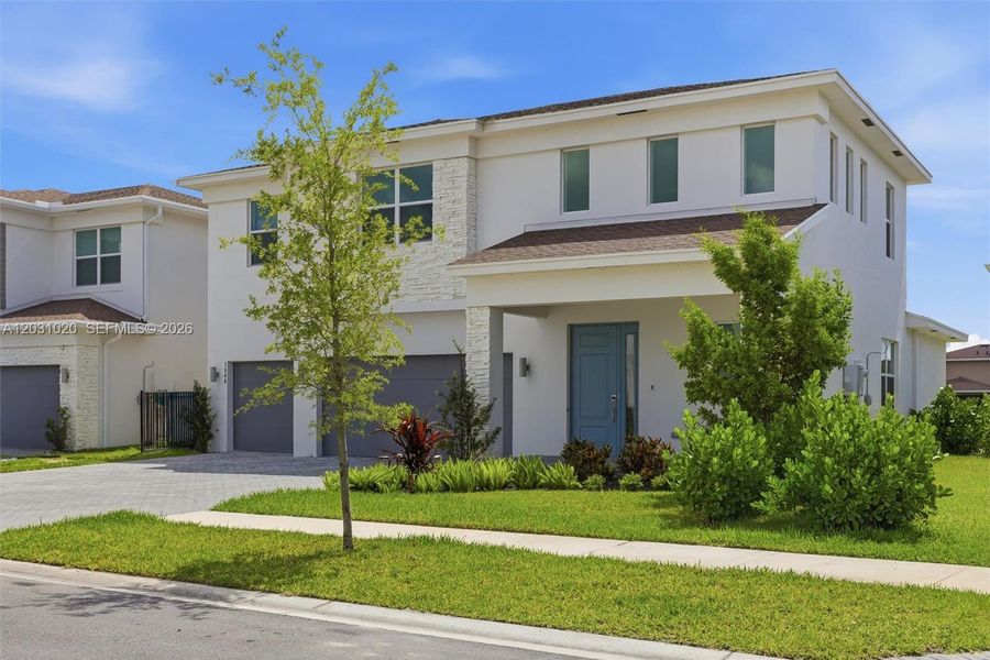 Front exterior of a new home in Arden, Loxahatchee, FL, highlighting curb appeal (Image 2).