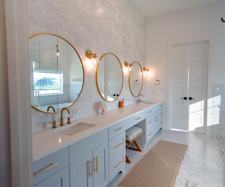 Full bathroom featuring double vanity and light tile patterned flooring Full bathroom featuring double vanity and light tile patterned flooring