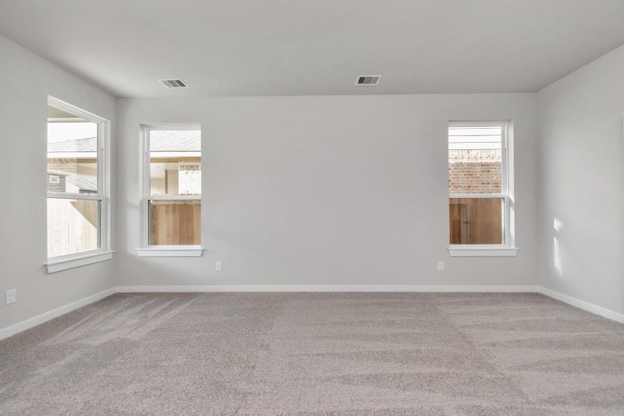 Large windows in the primary room for a bright and welcoming feel. Sample photo of completed home with similar floor plan. As-built interior colors and selections may vary. Large windows in the primary room for a bright and welcoming feel. Sample photo of completed home with similar floor plan. As-built interior colors and selections may vary.