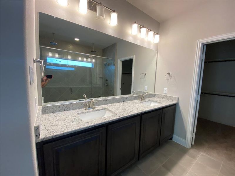 Spa-like master bathroom with dual vanities and granite counters