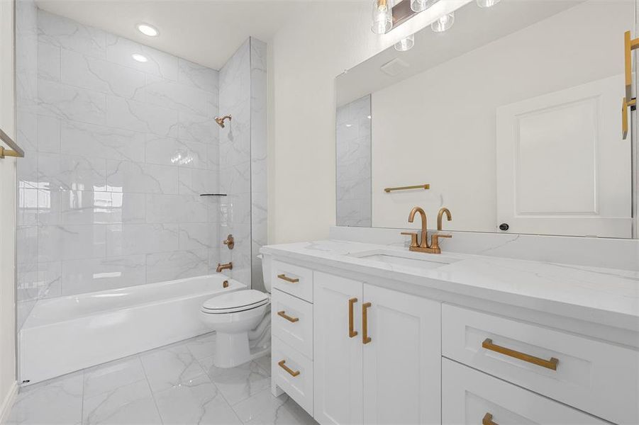 Bathroom featuring shower / bath combination, vanity, light marble finish floors, and recessed lighting Bathroom featuring shower / bath combination, vanity, light marble finish floors, and recessed lighting
