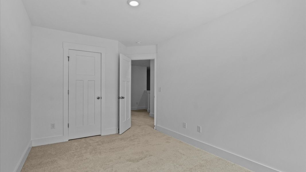 Highly functional bedroom with walk-in closet and tasteful carpet for a restful retreat Highly functional bedroom with walk-in closet and tasteful carpet for a restful retreat