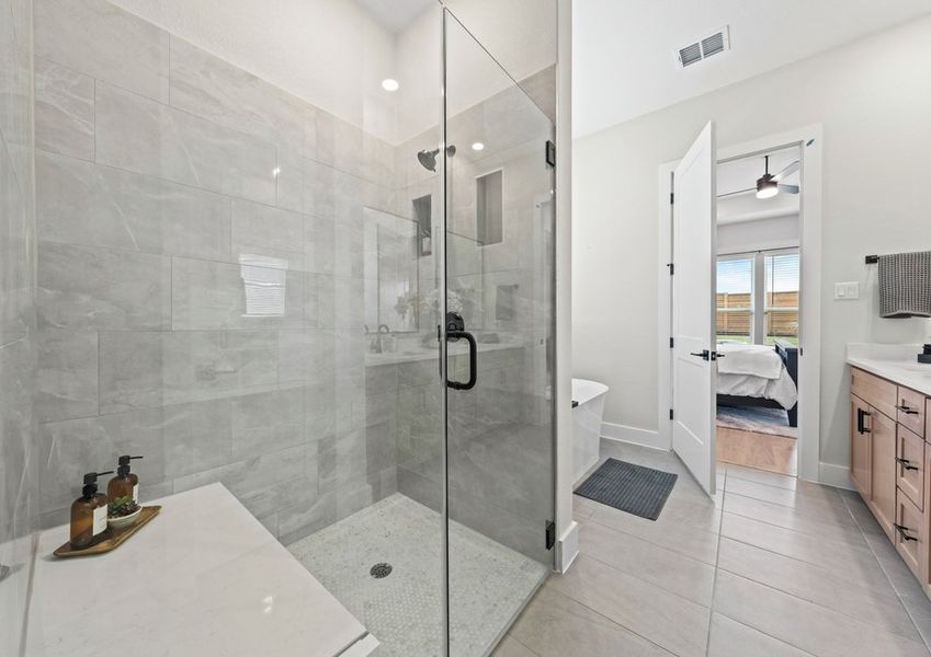 The master bathroom has a glass, walk-in shower.