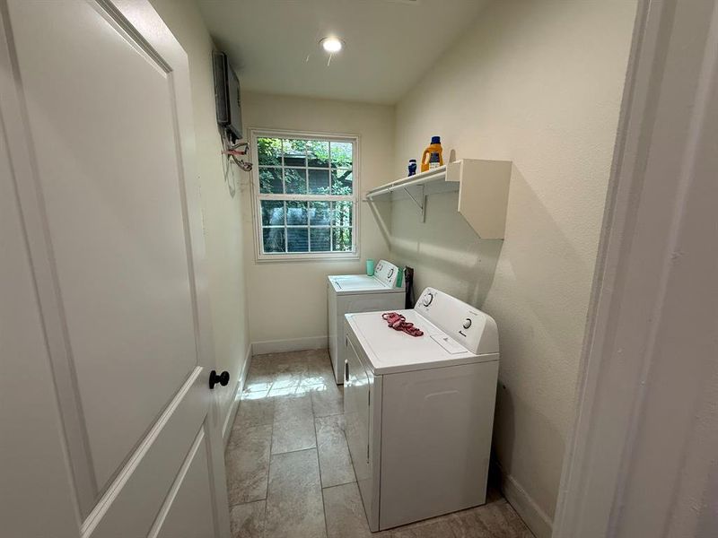 Washroom with washer and clothes dryer and recessed lighting