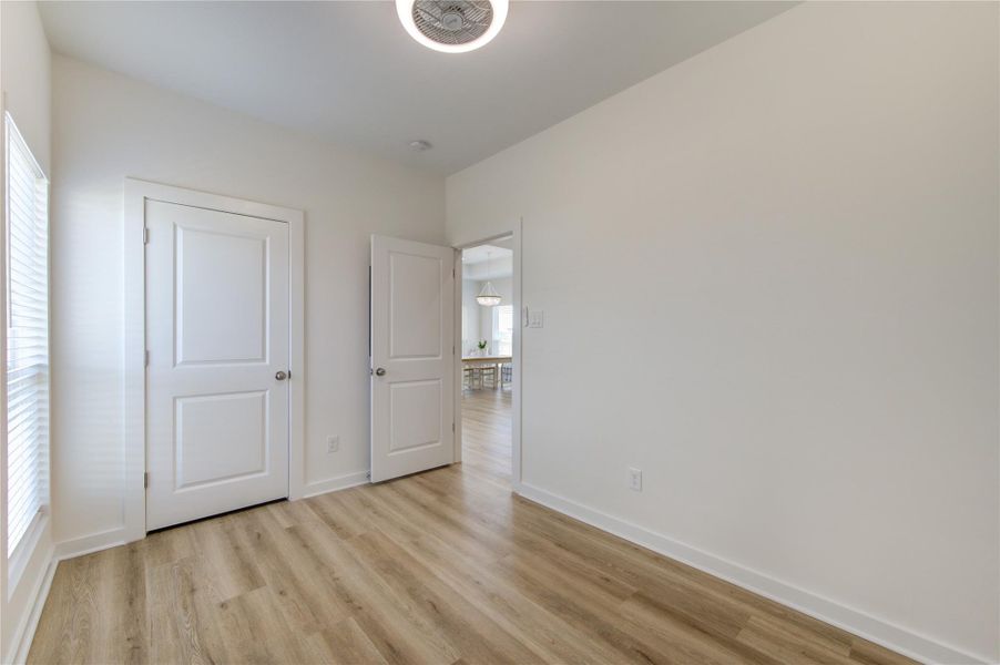 Bright secondary bedroom with natural light and closet space