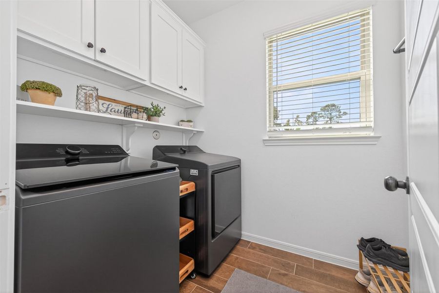 Elevate your daily routine in this bright laundry room, featuring custom-built cabinets that blend style with functionality. Elevate your daily routine in this bright laundry room, featuring custom-built cabinets that blend style with functionality.