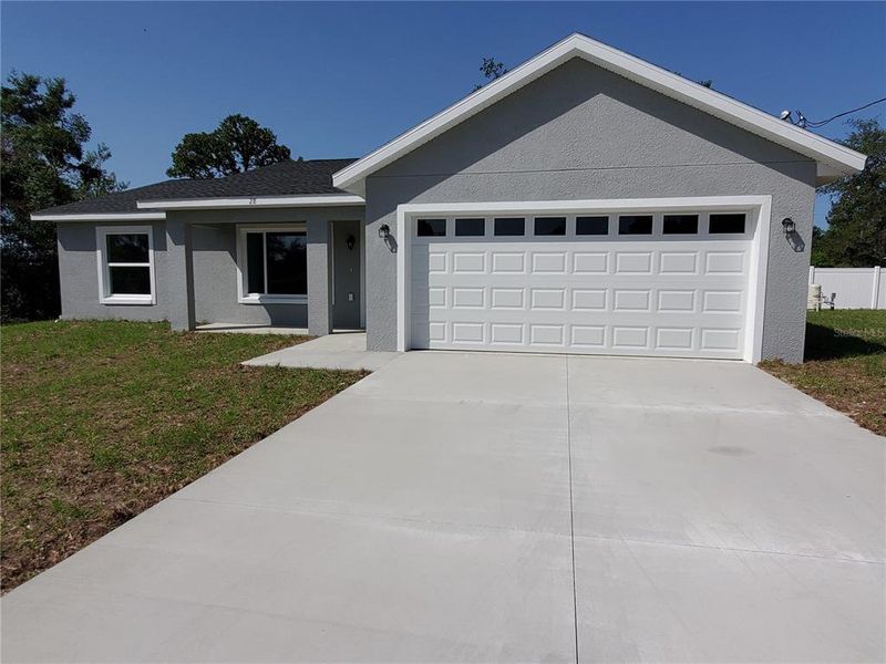 Front exterior of a new home in , Ocklawaha, FL, highlighting curb appeal (Image 1).