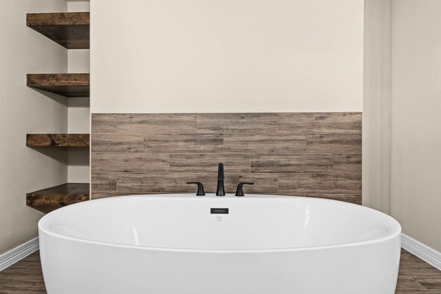 Bathroom featuring wood like tile floors and a freestanding bath Bathroom featuring wood like tile floors and a freestanding bath