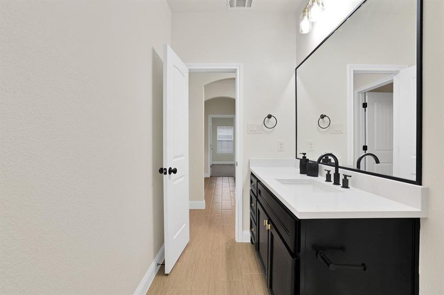 Bathroom featuring vanity and wood-type flooring