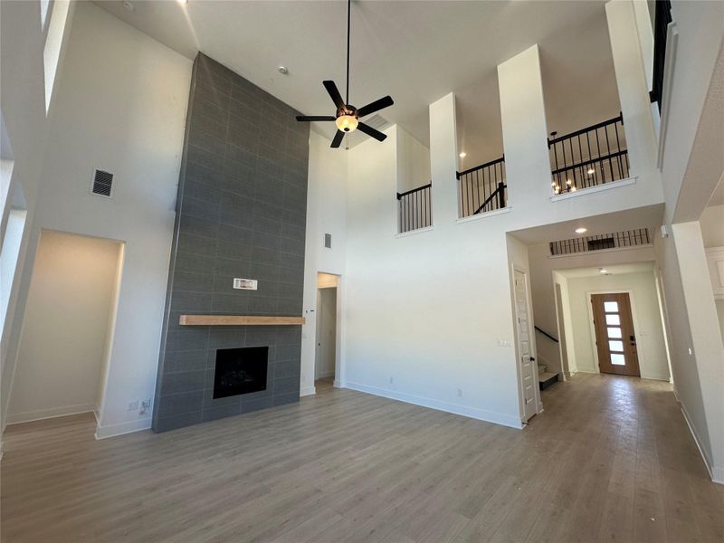 Family Room with soaring ceiling & fireplace