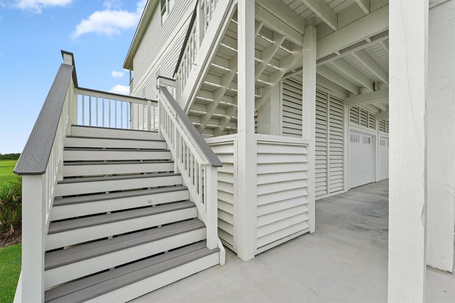 Wide staircase entry welcomes you home with elevated coastal charm and storm-rated construction. Wide staircase entry welcomes you home with elevated coastal charm and storm-rated construction.