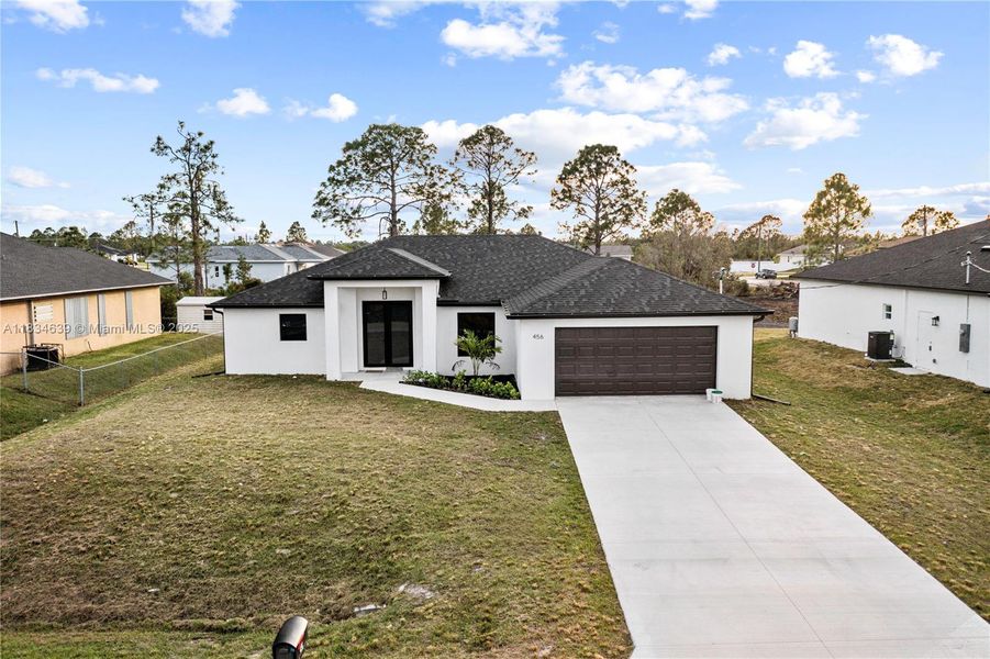 Front exterior of a new home in , Lehigh Acres, FL, highlighting curb appeal (Image 1). Front exterior of a new home in , Lehigh Acres, FL, highlighting curb appeal (Image 1).