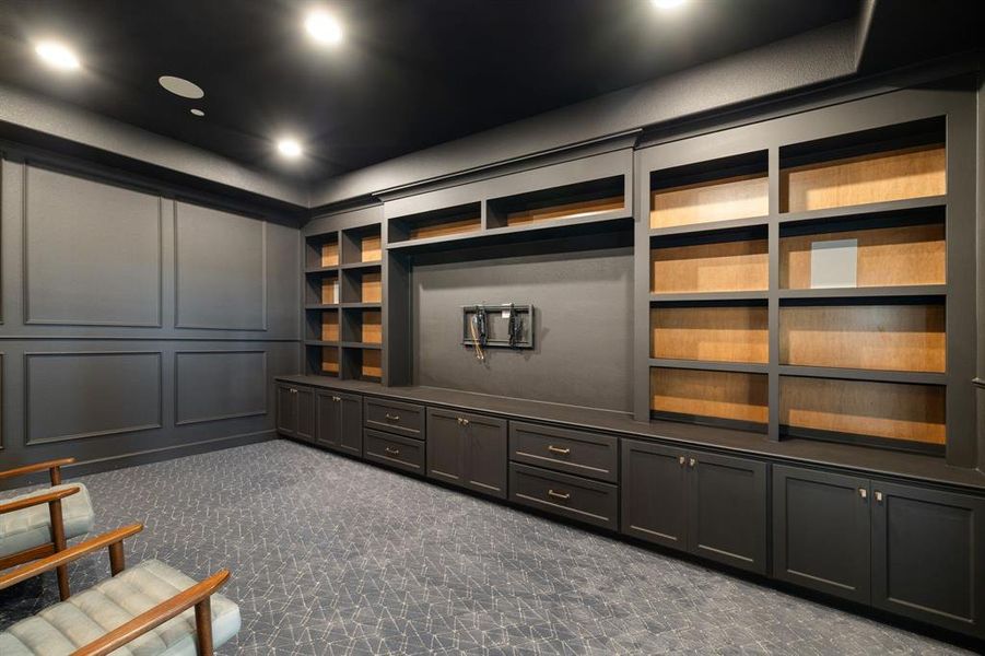 Cinema room with recessed lighting, a decorative wall, and dark colored carpet Cinema room with recessed lighting, a decorative wall, and dark colored carpet