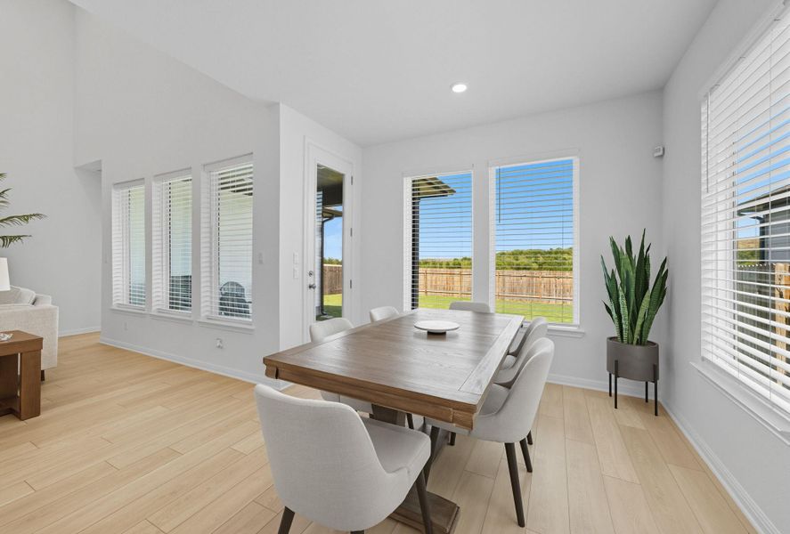 Dining room with light wood-style flooring and recessed lighting Dining room with light wood-style flooring and recessed lighting