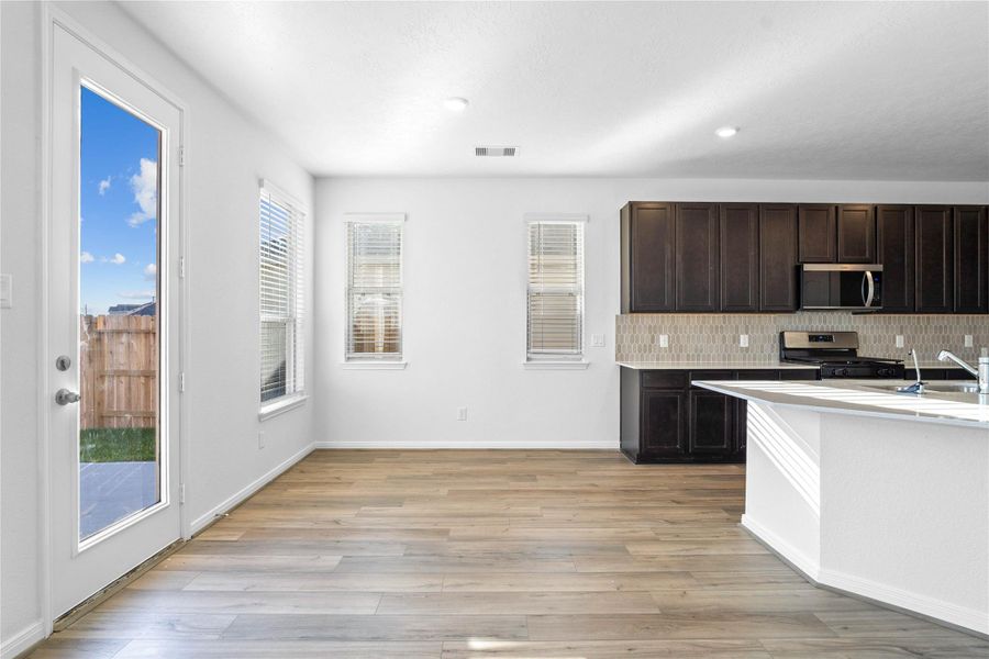 Effortless entertaining in this open dining space. A seamless layout connects your kitchen and living areas, putting you right in the heart of the action. It features plenty of windows with privacy blinds, access door to the back patio and yard, vinyl plank flooring and recessed lighting. Effortless entertaining in this open dining space. A seamless layout connects your kitchen and living areas, putting you right in the heart of the action. It features plenty of windows with privacy blinds, access door to the back patio and yard, vinyl plank flooring and recessed lighting.