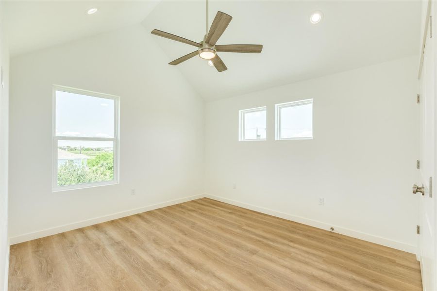 Bedroom 1 located on second floor with 12 foot vaulted ceiling.