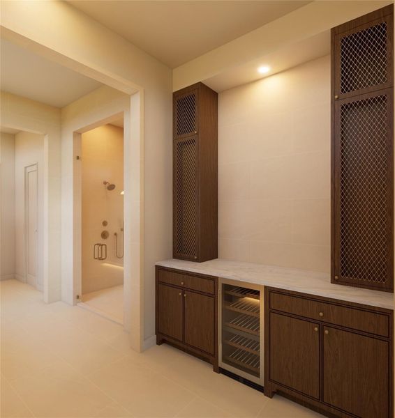 A refined blend of utility and design, this built-in beverage station adds an unexpected layer of convenience. Tailored millwork, stone surfaces, and subtle illumination create a space that feels curated, not purely functional.