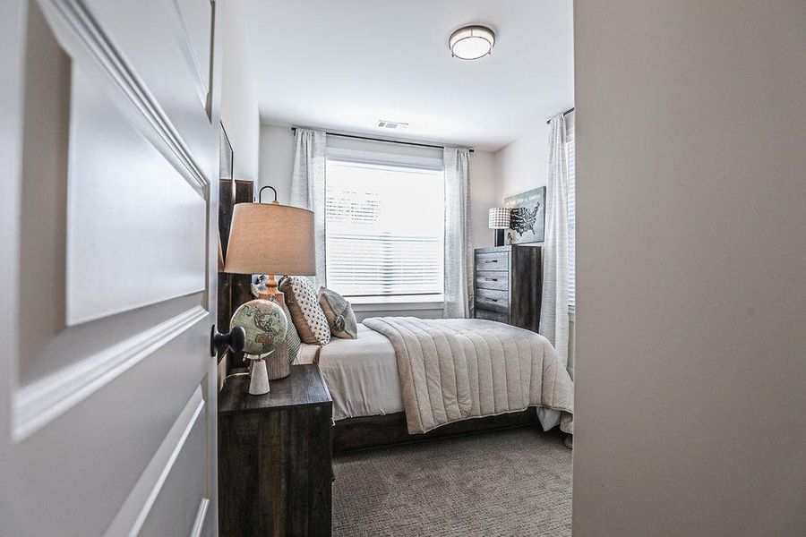 Bedroom featuring dark carpet