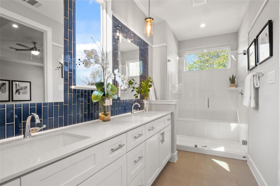 Full bath with double vanity, a stall shower, backsplash, recessed lighting, and tile patterned floors Full bath with double vanity, a stall shower, backsplash, recessed lighting, and tile patterned floors