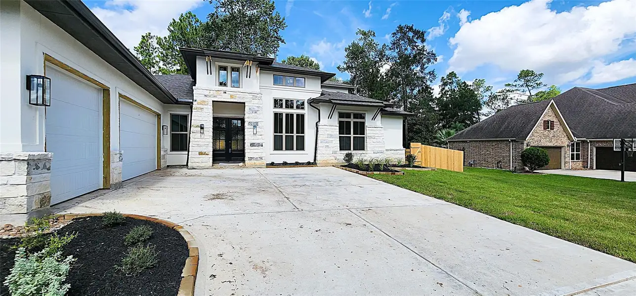 Front exterior of a new home in Stewart’s Forest, Conroe, TX, highlighting curb appeal (Image 2). Front exterior of a new home in Stewart’s Forest, Conroe, TX, highlighting curb appeal (Image 2).