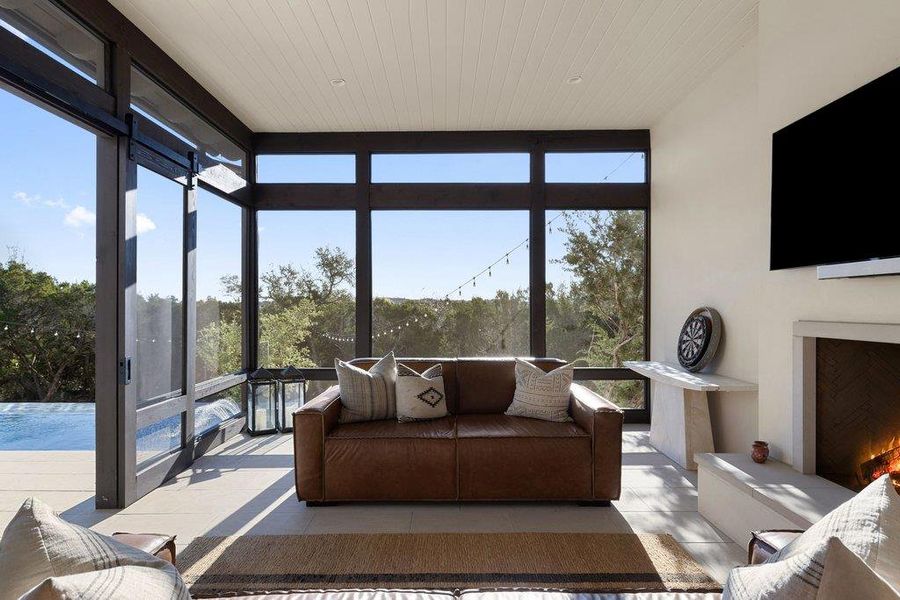 Sunroom / solarium featuring floor to ceiling windows, tile patterned flooring, and wood ceiling