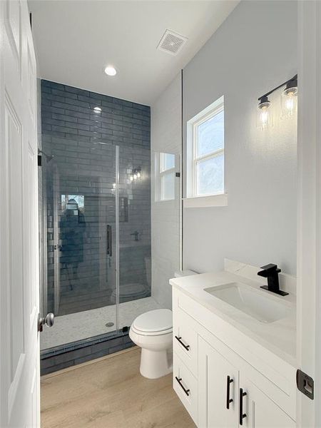 Luxurious bathroom featuring a sleek glass shower and exquisite details for an exceptional experience.