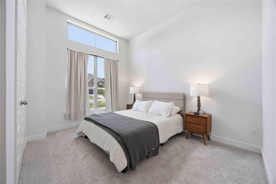 Designed to provide both comfort and privacy, this secondary bedroom offers generous proportions and sophisticated design details.