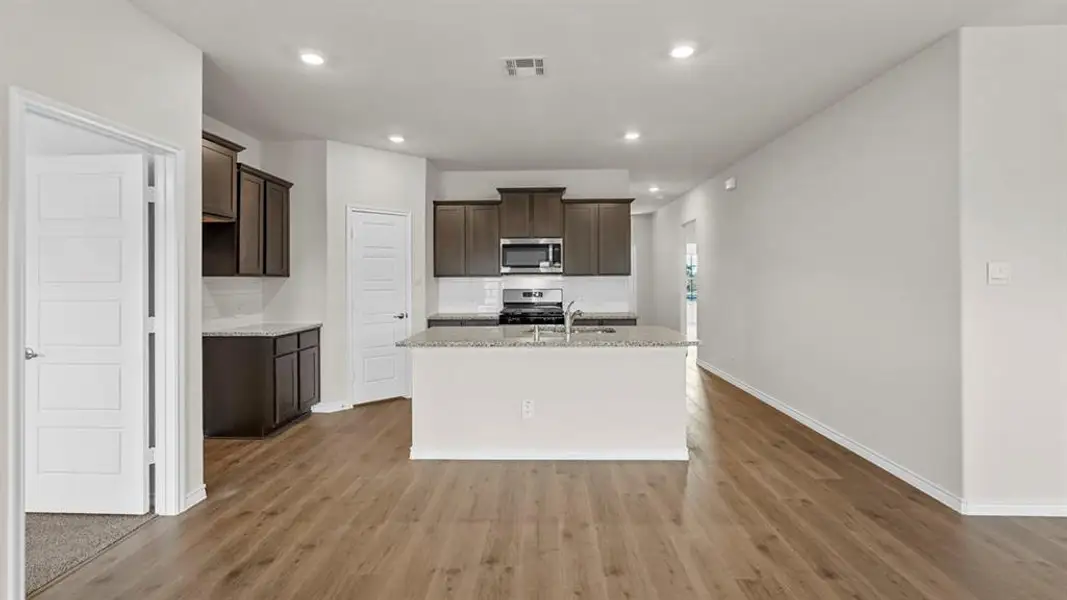 Open-concept living area with wood-finish flooring
