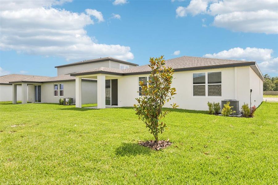 Front exterior of a new home in Two Rivers - Classic Series, Zephyrhills, FL, highlighting curb appeal (Image 17).