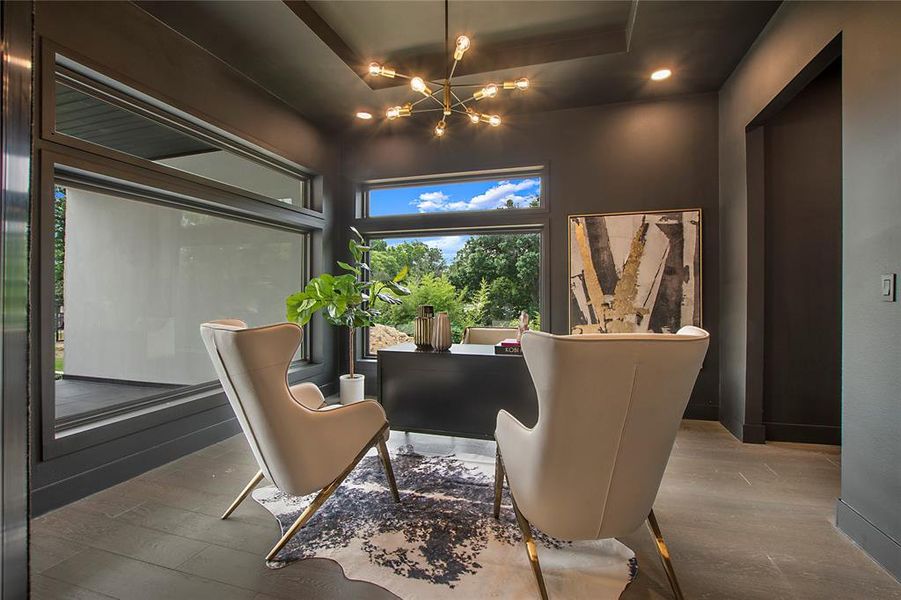 Sitting room featuring a notable chandelier, a tray ceiling, and hardwood / wood-style floors