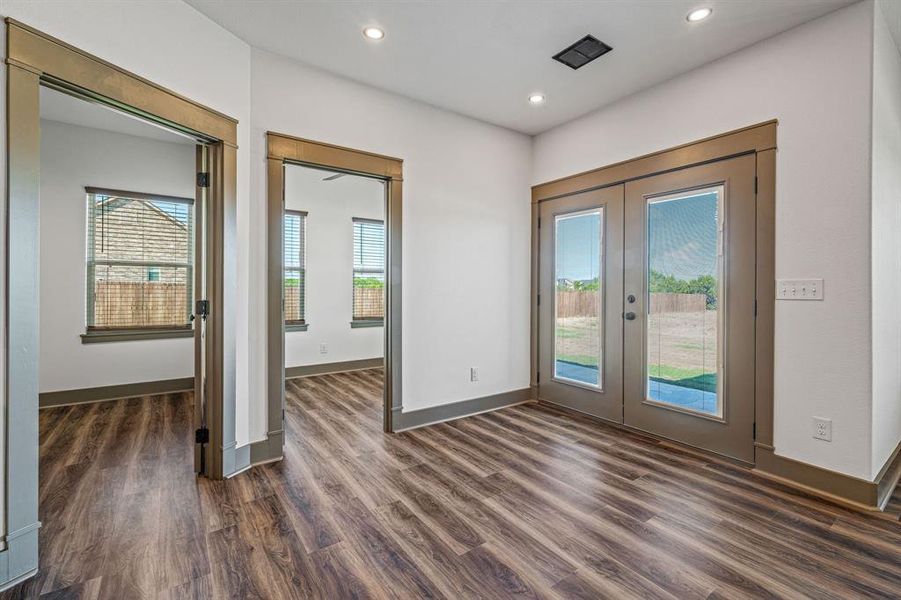 Entryway featuring plenty of natural light, wood finished floors, french doors, and recessed lighting