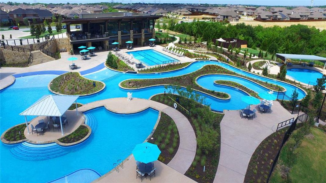 View of swimming pool featuring a hot tub and a patio