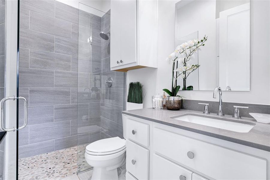 Indulge in the ultimate relaxation experience as you step into the spacious shower, complete with modern fixtures and a soothing water flow. This ensuite primary bath offers privacy and convenience.