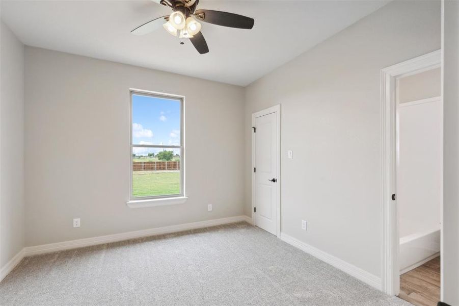 Spare room with light carpet and ceiling fan