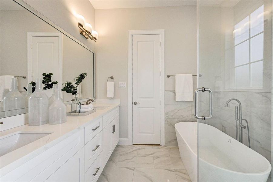 View of the Master Bath with dual vanities, Walk-in Shower and a Modern Oval Freestanding bathtub.