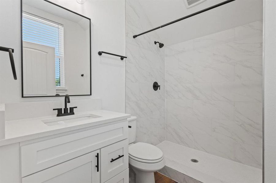 Full bathroom featuring vanity and a stall shower