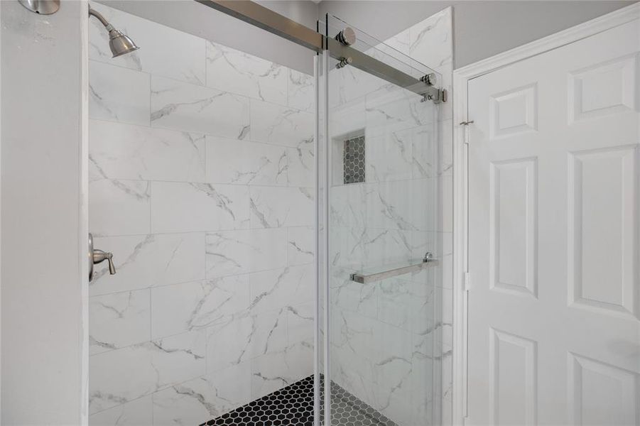 Bathroom featuring a marble finish shower Bathroom featuring a marble finish shower