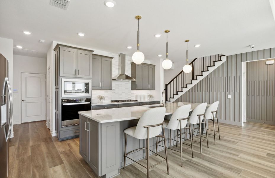 Eat-in island in kitchen with pendant lighting