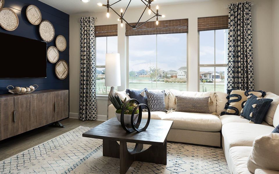 Living room featuring wood finished floors and a chandelier Living room featuring wood finished floors and a chandelier