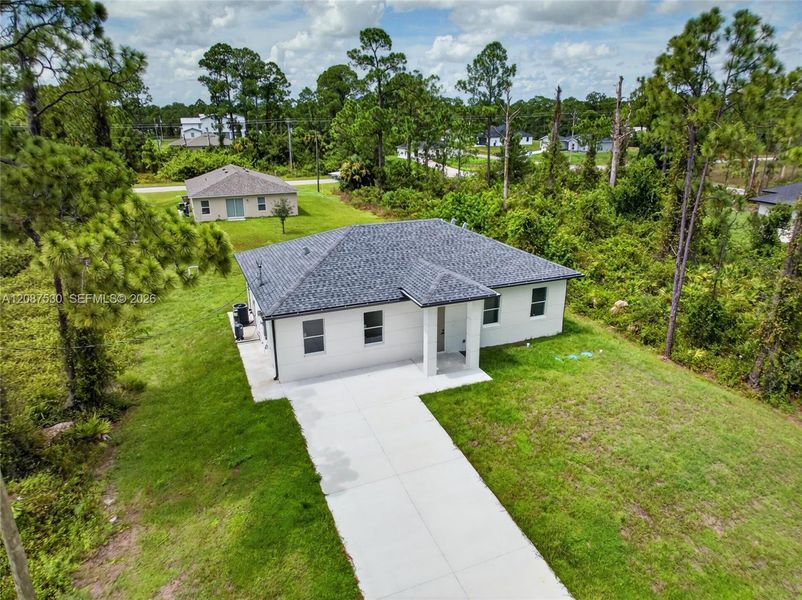 Front exterior of a new home in , Lehigh Acres, FL, highlighting curb appeal (Image 19).
