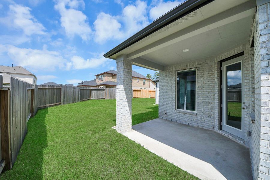 Experience outdoor living at its finest on this expansive covered patio, thoughtfully designed for BBQs and delightful outdoor dining.