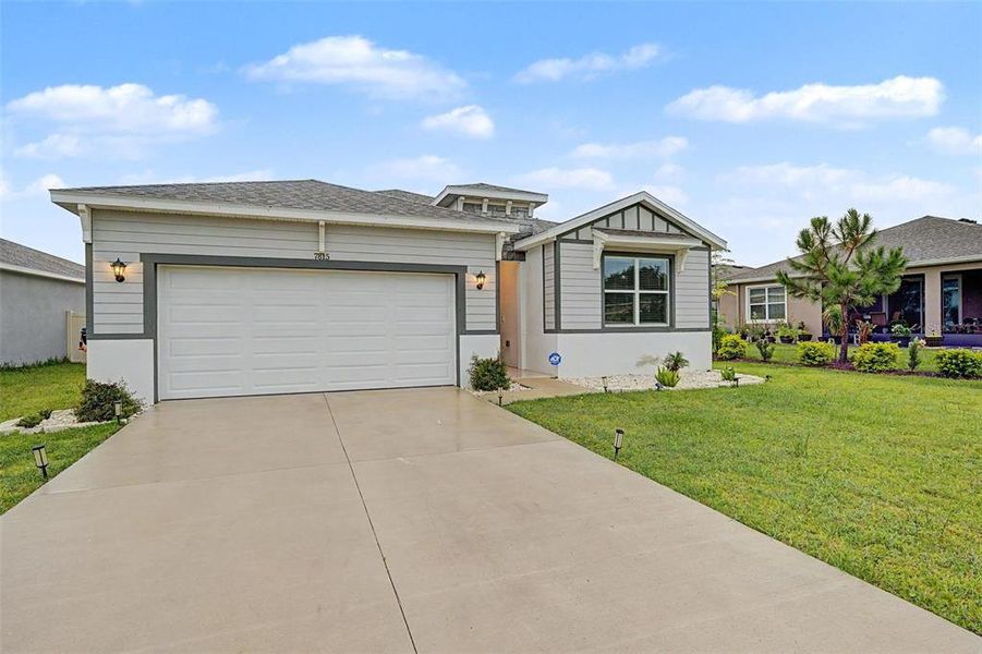 Front exterior of a new home in Abbott Park, Zephyrhills, FL, highlighting curb appeal (Image 22).