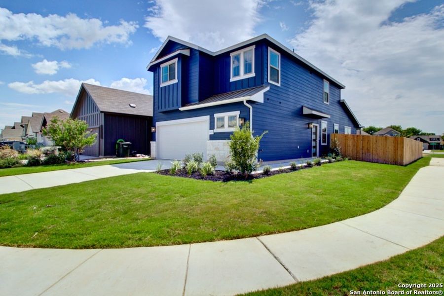 Front exterior of a new home in Casinas at Gruene, New Braunfels, TX, highlighting curb appeal (Image 1). Front exterior of a new home in Casinas at Gruene, New Braunfels, TX, highlighting curb appeal (Image 1).