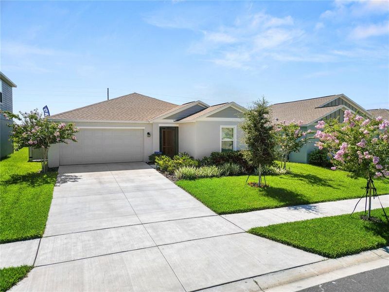 Front exterior of a new home in Hunt Club Groves, Lake Wales, FL, highlighting curb appeal (Image 23).