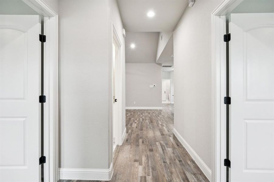 Hall featuring wood finished floors and recessed lighting