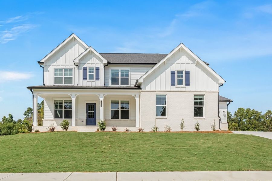 A white house with a lawn.