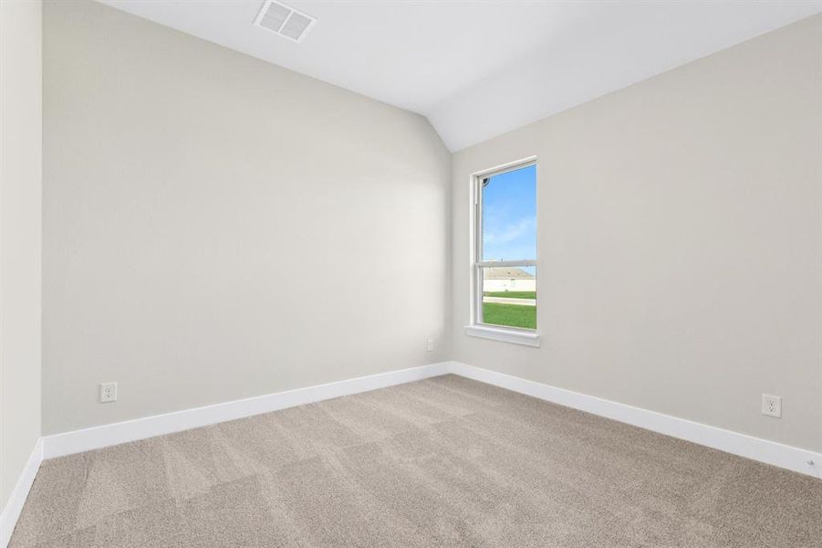 Spare room featuring carpet flooring and vaulted ceiling Spare room featuring carpet flooring and vaulted ceiling