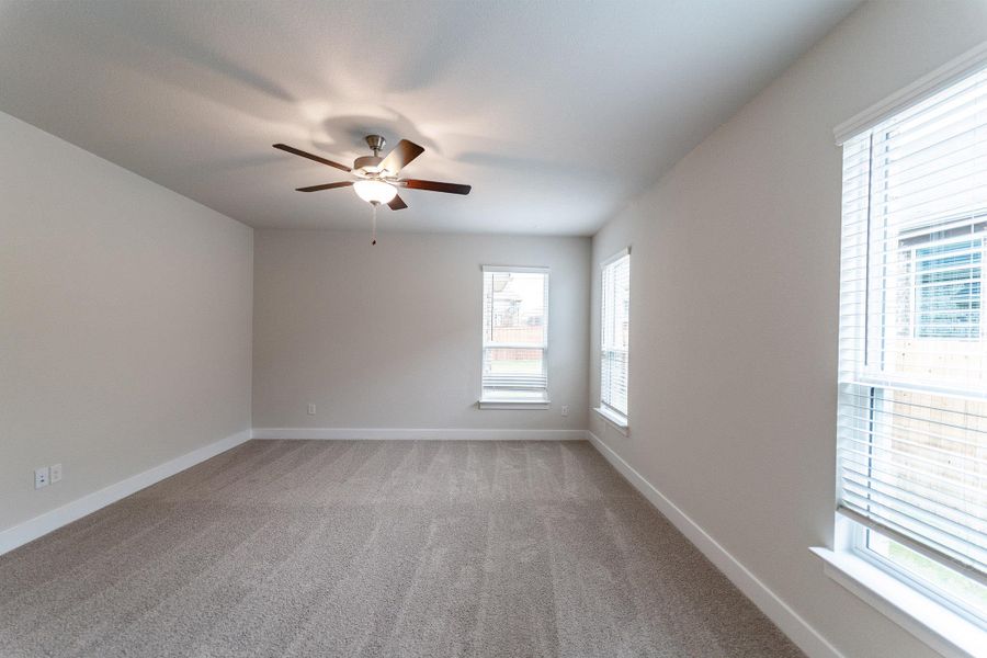 Spare room with light carpet and ceiling fan