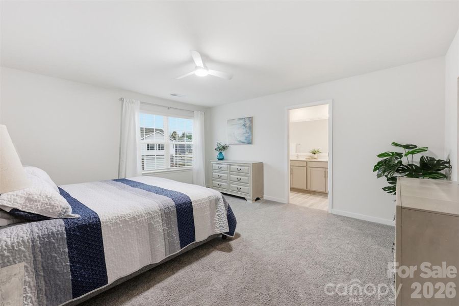 primary bedroom, walk in closet, ensuite with walk in shower, water closet, and linen closet.